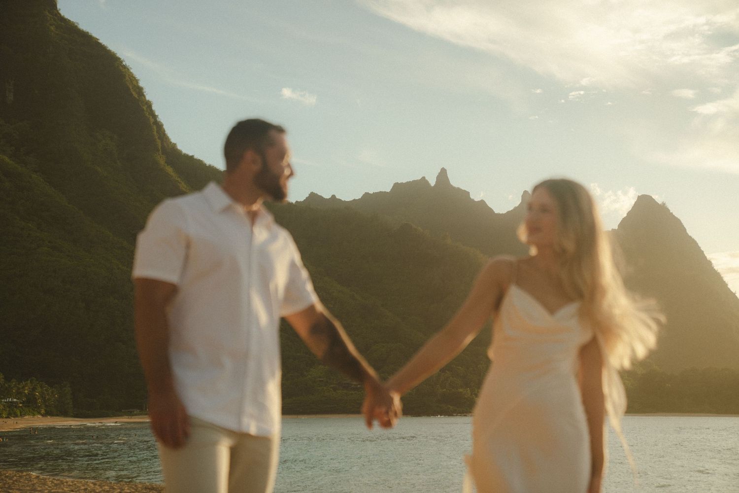 Couple at tunnels brach at sunset by Hawai'i Wedding Photographer