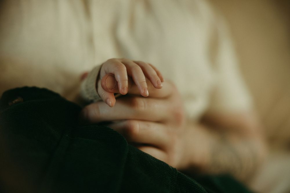 Close-up details of hands and gentle movements in warm, dreamy lighting.