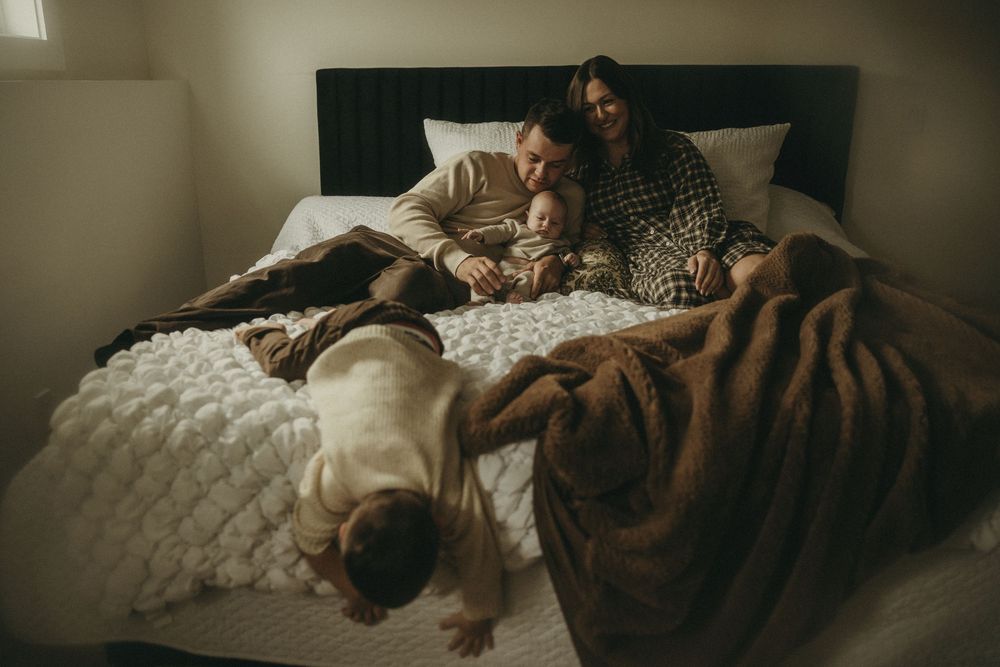 Relaxed lifestyle photos taken on a comfortable bed with textured bedding.