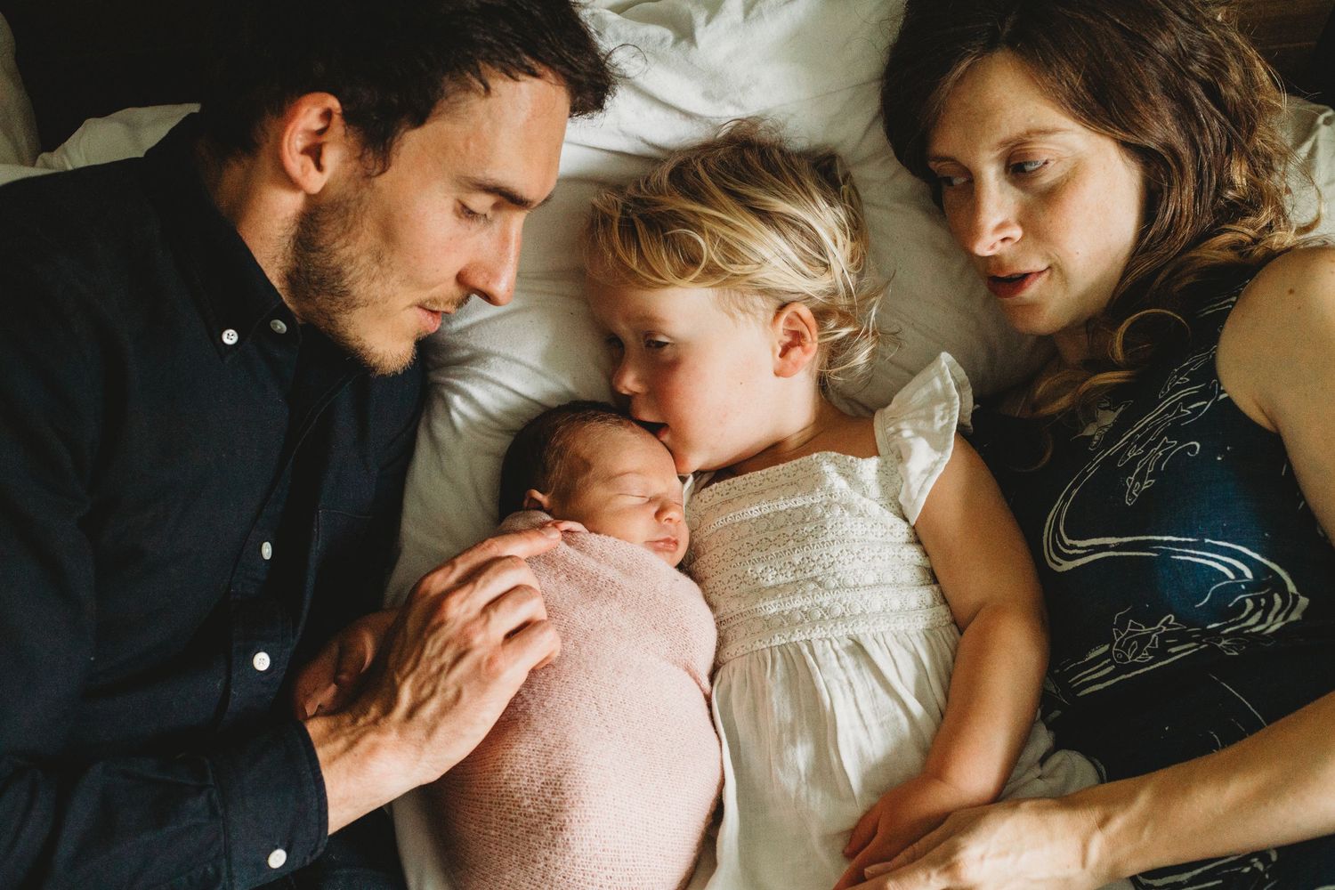Close-up of tender family moment with sleeping newborn in natural light. Annapolis newborn photographer