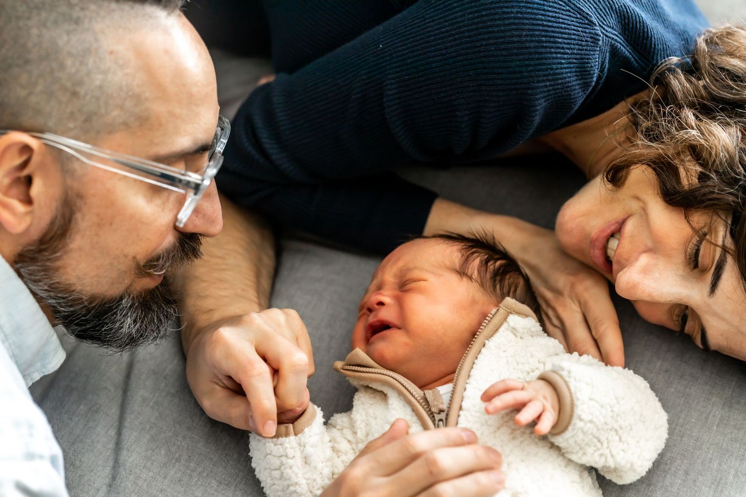 Close-up lifestyle photos capture sweet bonding moments with a sleeping newborn. Annapolis newborn photographer