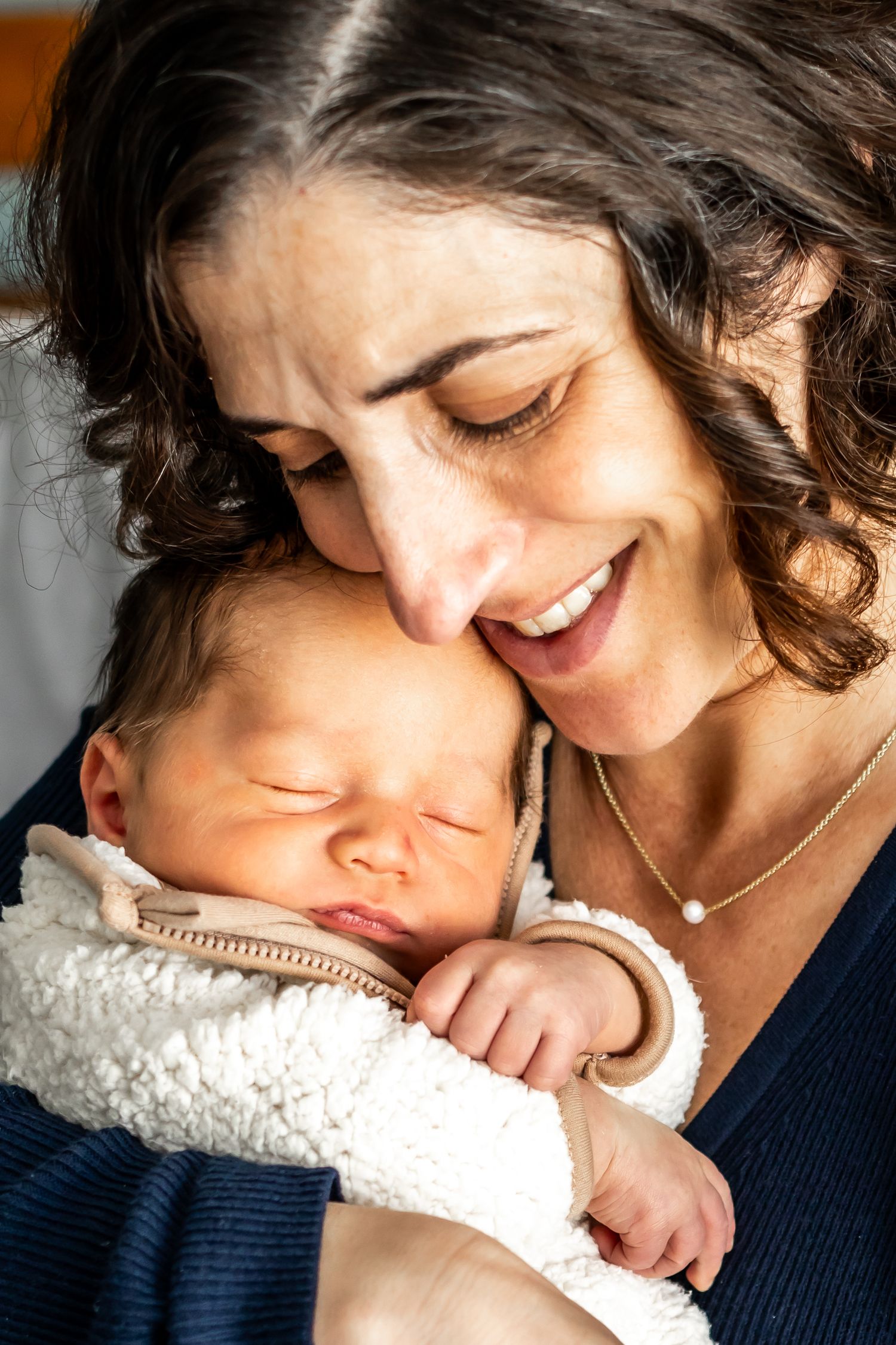 Intimate lifestyle photography captures emotional bonding moments with a newborn.