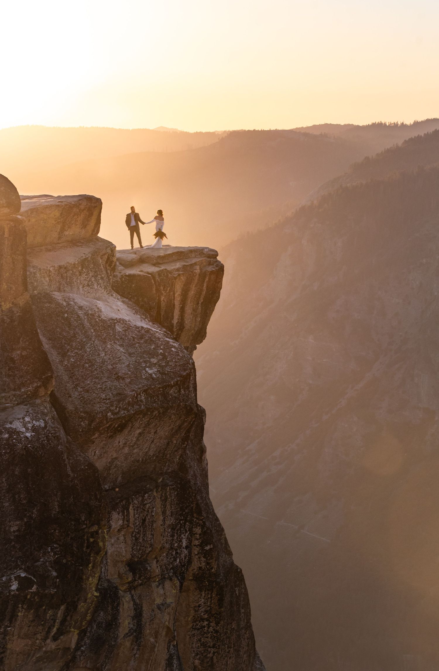 An epic elopement in the golden light of sunset view, Taft Point, Yosemite