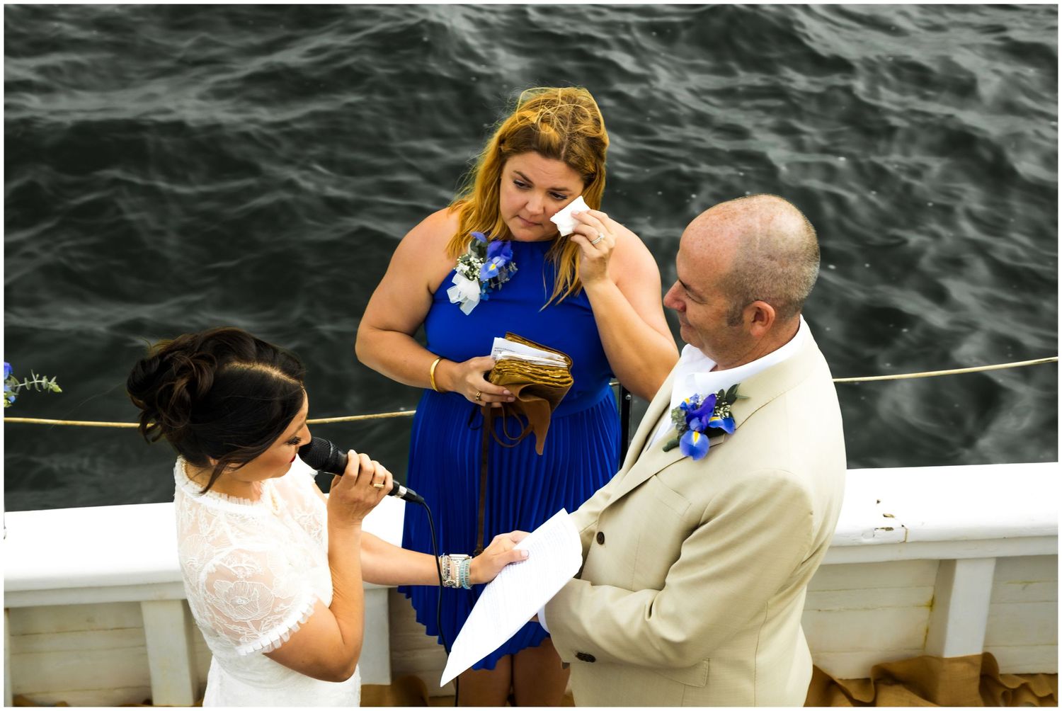 aboard a boat with attendees in blue and white attire on The Bill of Rights Shot By Zeus Holbrook San Diego Wedding Photographer