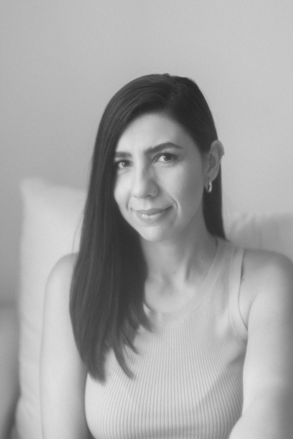 Dreamy black and white portrait in soft focus showing warm expression.