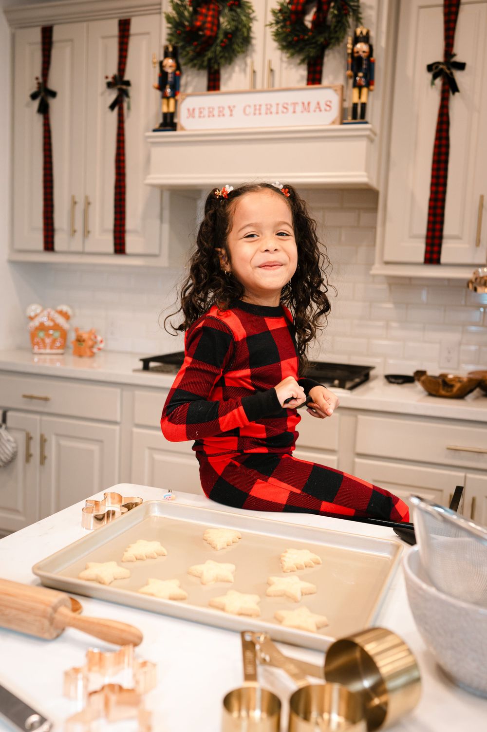 Holiday kitchen scene with Christmas decorations and baking preparations.