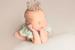 A series of soft, minimalist baby portraits showing tiny feet and legs against a neutral beige background.
