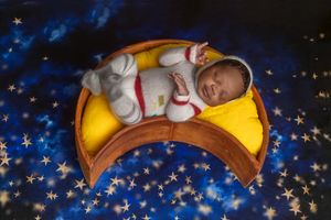 A series of four celestial-themed newborn photos showing a sleeping baby on crescent moon props with twinkling stars.