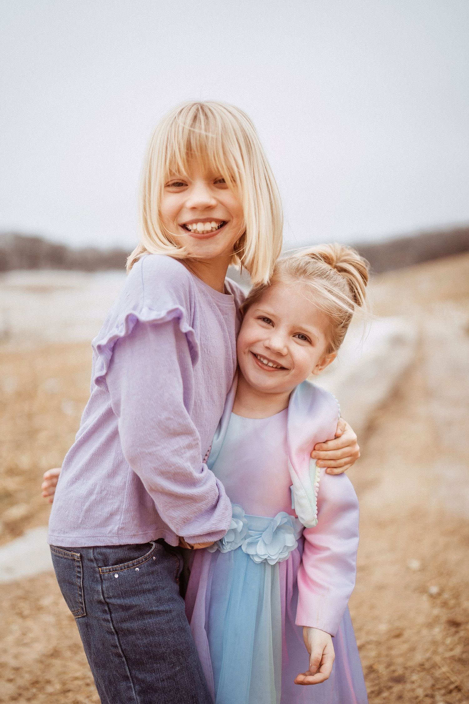 Wisconsin photographer capturing sisters in an open field.