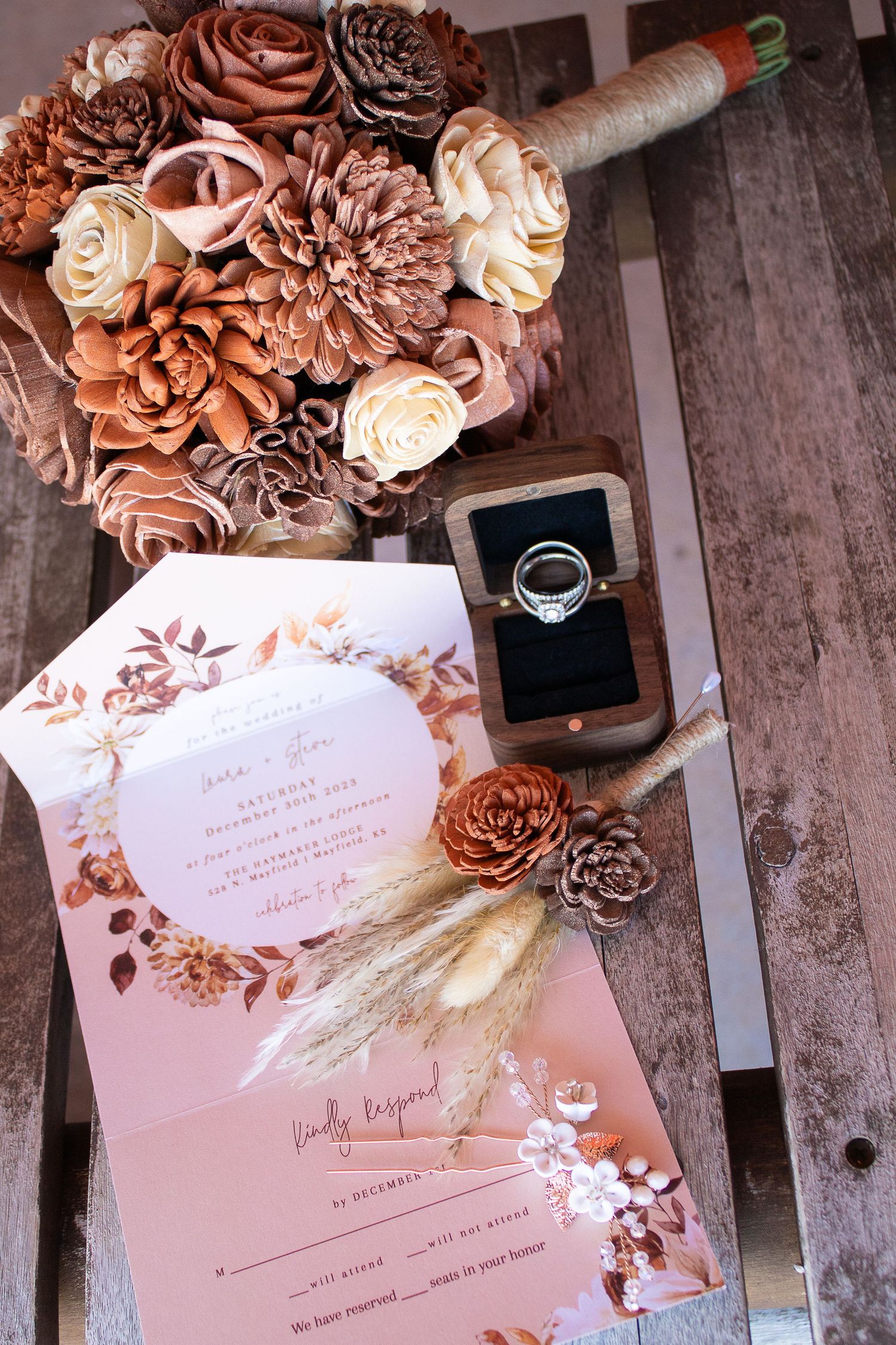 Wedding invitation with dusty rose floral decorations and rustic details.