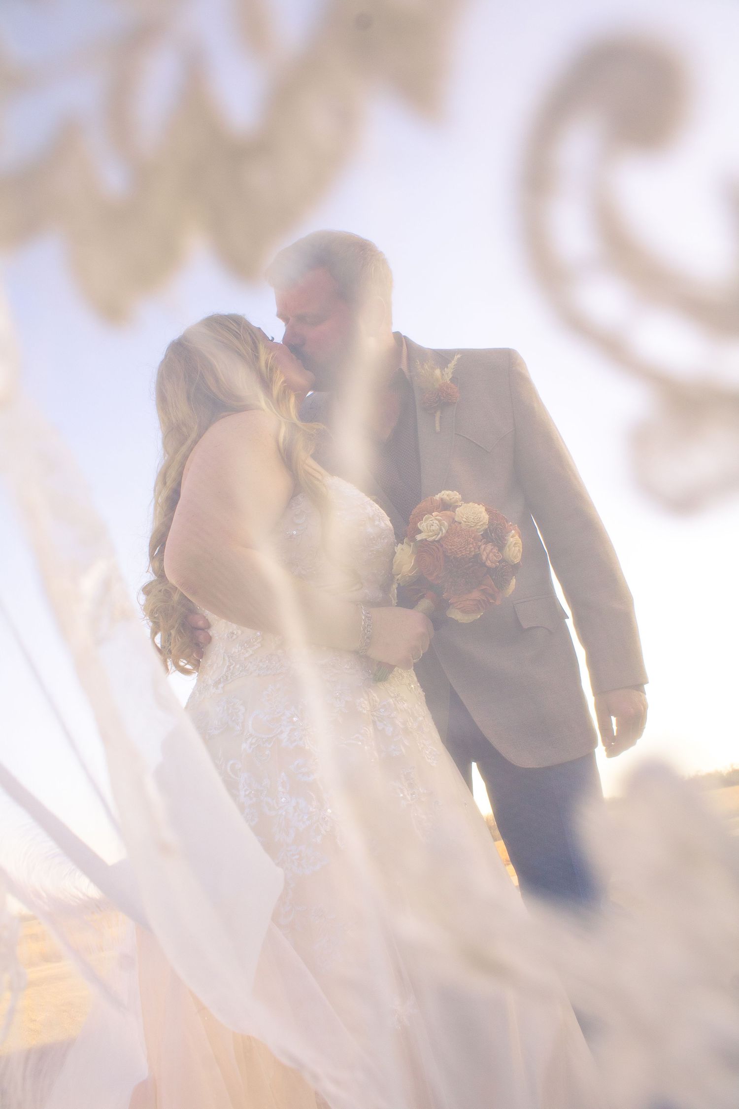 Newlyweds share an intimate moment during their sunset wedding photoshoot.