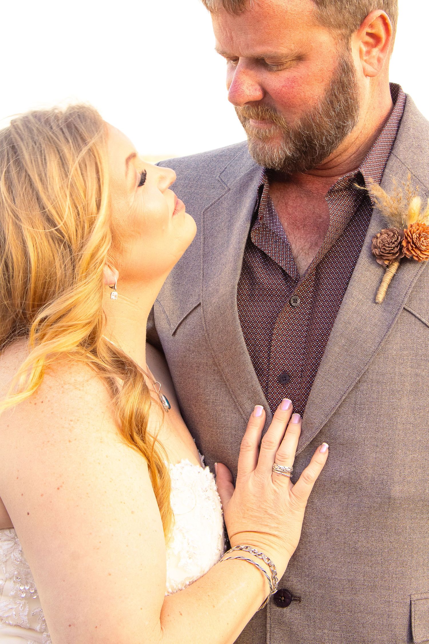 Romantic couple sharing intimate moment during wedding ceremony.