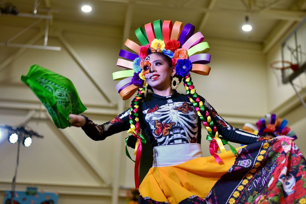 Photograph of Day of the Dead Dia de Los Muertos event with people in costume at the Community Center in San Rafael by William Wayland