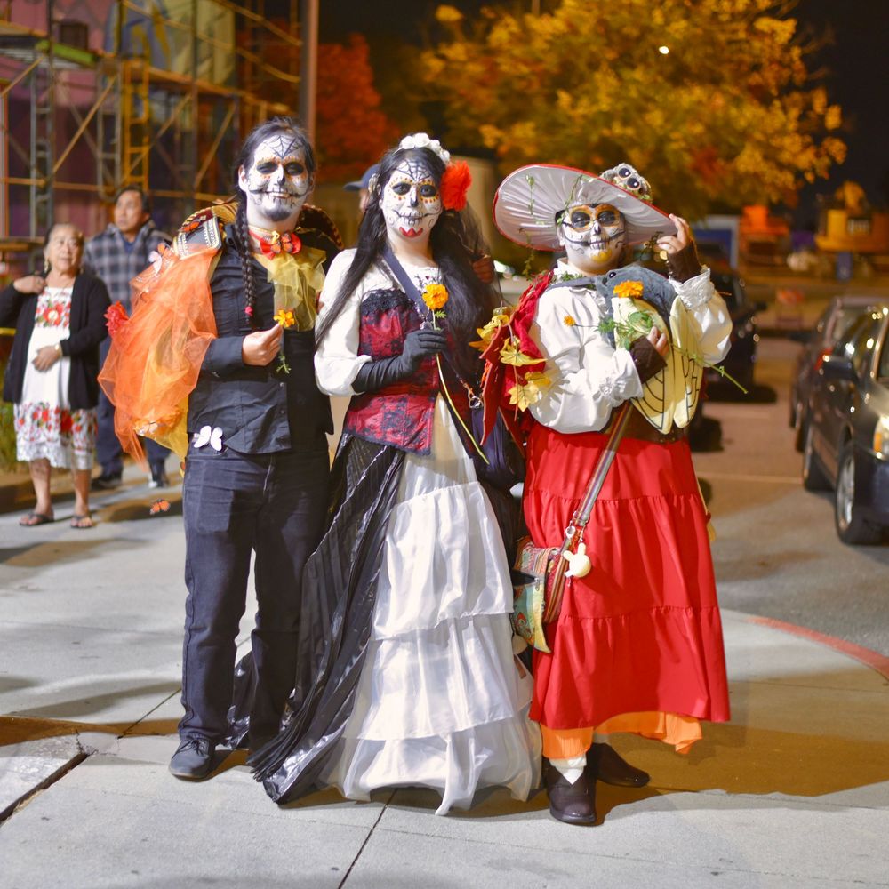 Photograph of Day of the Dead Dia de Los Muertos event with people in costume at the Community Center in San Rafael by William Wayland