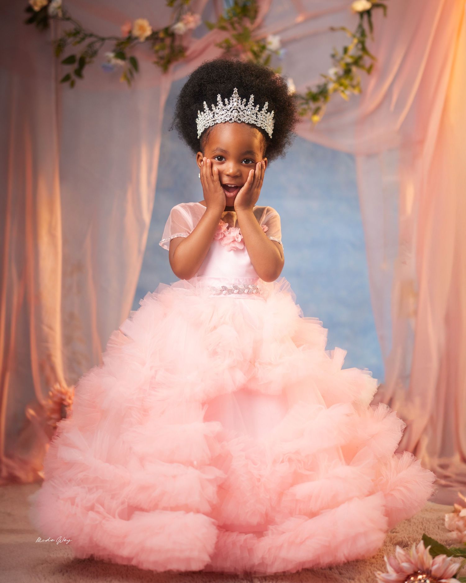 A series of photos showing a child in a pink tulle dress twirling and playing in a dreamy forest setting.