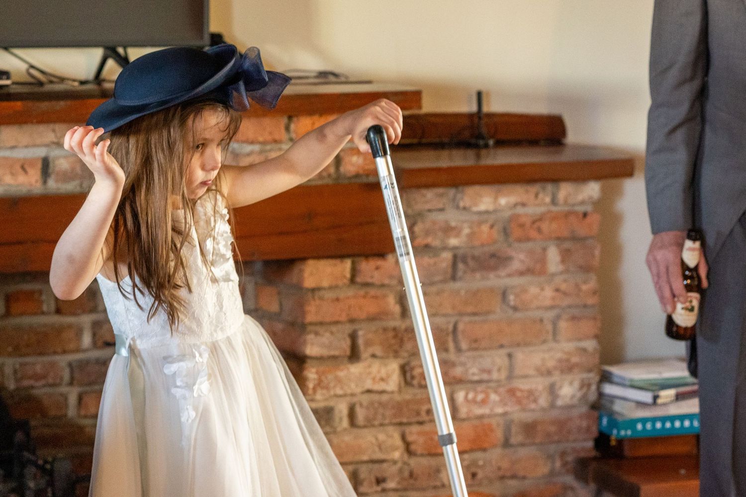 Flower girl wearing a large hat and holding a walking cane inside the windmill at Windmill Farm in Burscough.