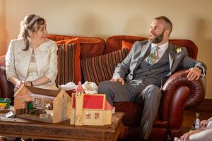 Bride and her son sitting on a sofa inside the windmill at Windmill Farm Burscough chatting during a quiet moment.
