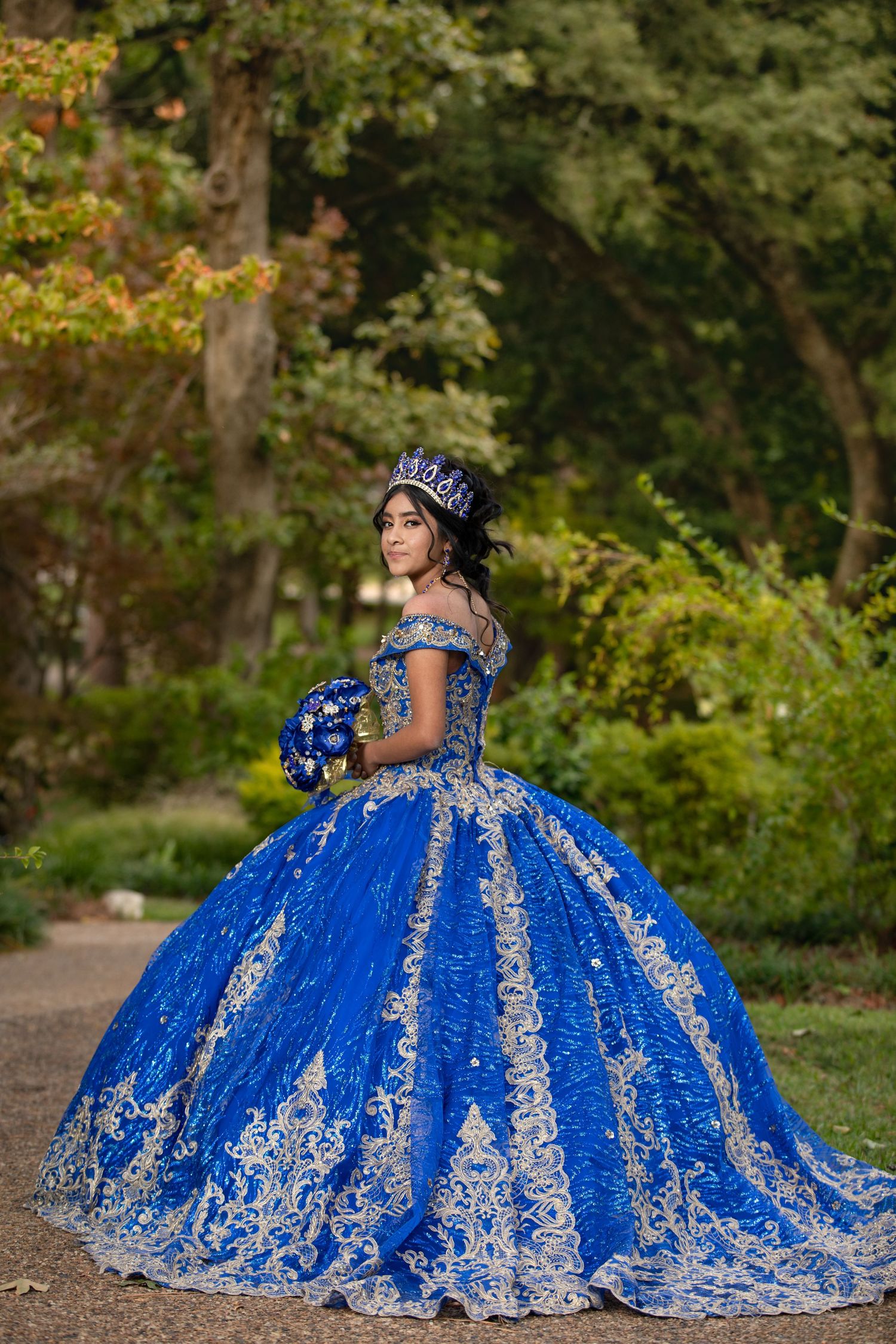 A couple in formal attire poses romantically across three frames, with the woman wearing a flowing navy blue tulle gown.