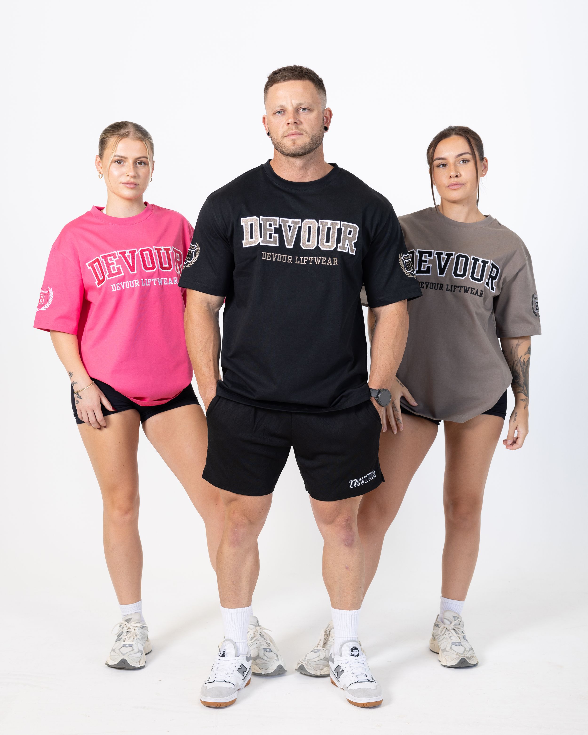 Models display athletic wear collection in black, gray and pink Beyoure branded t-shirts and shorts.