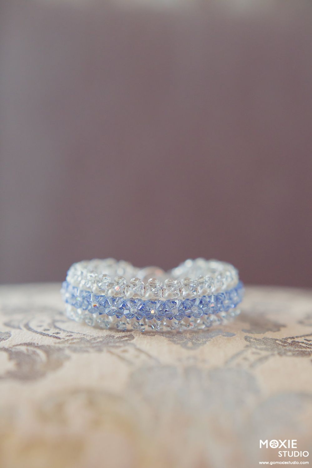 Close-up detail shot of delicate crystal jewelry with sparkling facets.