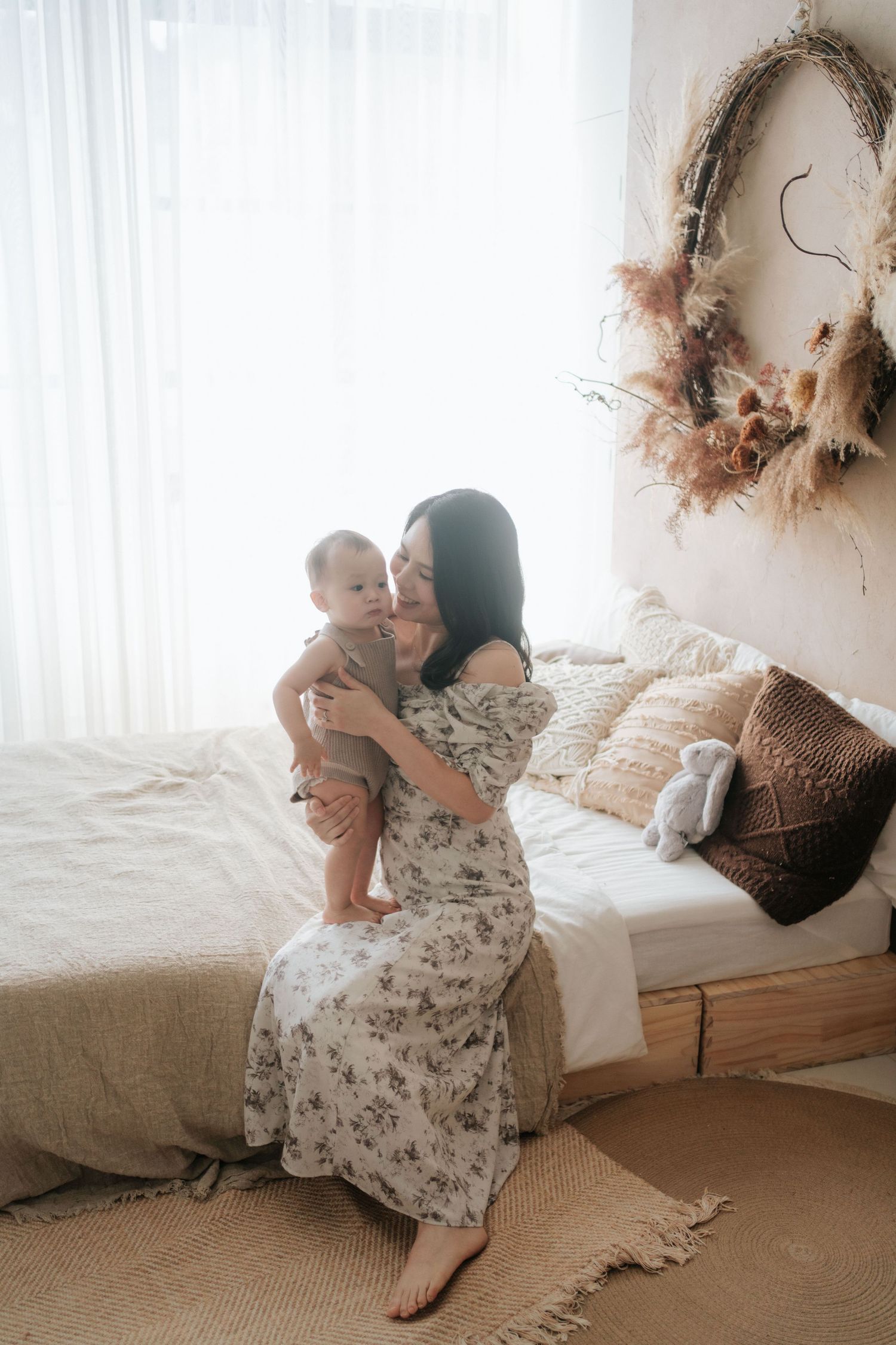 Romantic vintage-style photo series showing intimate moments on a sunlit bed with soft floral dress and dreamy atmosphere.
