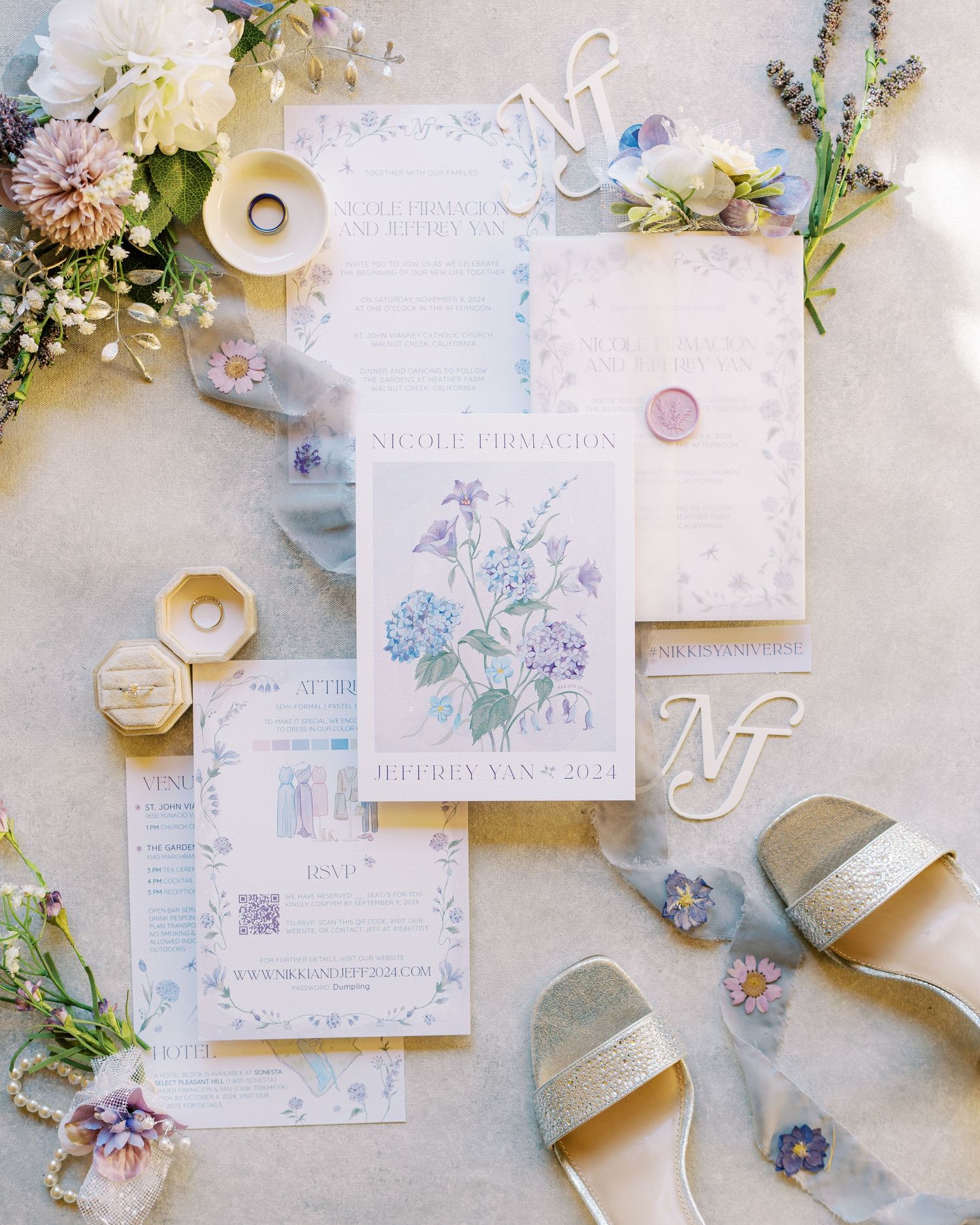 Wedding stationery suite with watercolor floral designs surrounded by flowers and sandals. Wedding flatlay