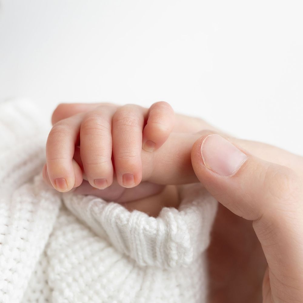 Newborn photo featuring mama's hands, taken by Jen Knightstep, Photographer