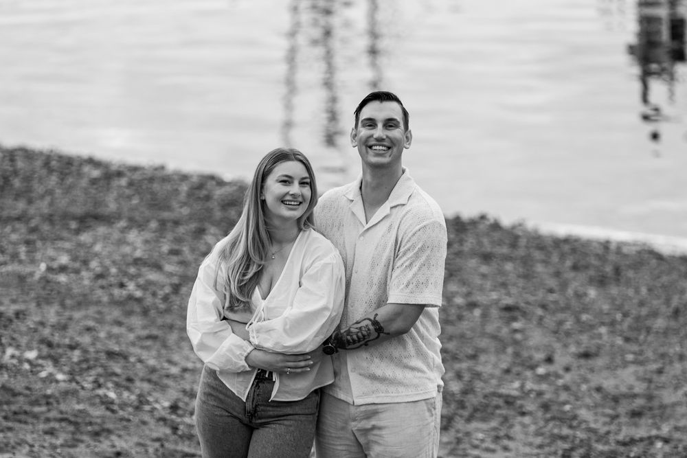 A series of black and white photographs showing a couple sitting and embracing outdoors.