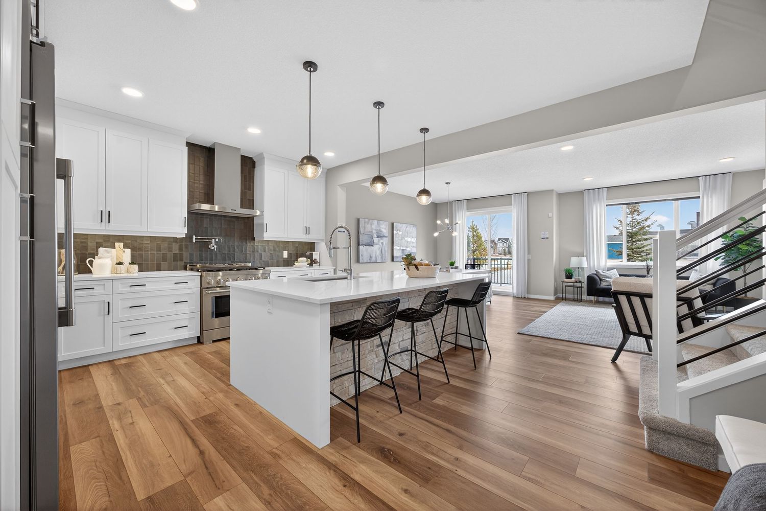 Contemporary open floor plan featuring modern lighting fixtures and minimalist interior design.