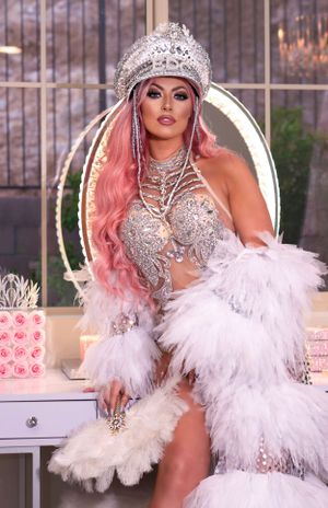 Glamorous photoshoot with white feathers, crystals and vintage-inspired styling.
