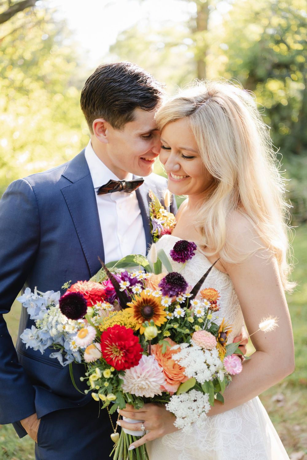 A romantic wedding photo series showing a couple with vibrant floral bouquets in an outdoor garden setting.