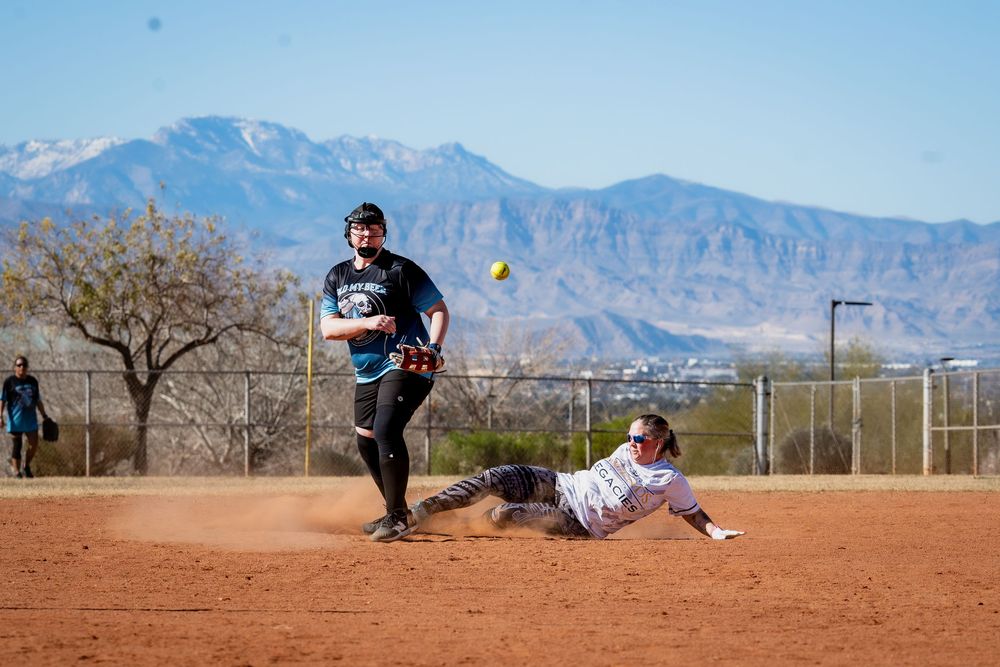 A runner at the Women's D softball tournament at Sin City Classic slides into second base while the defender misses the ball