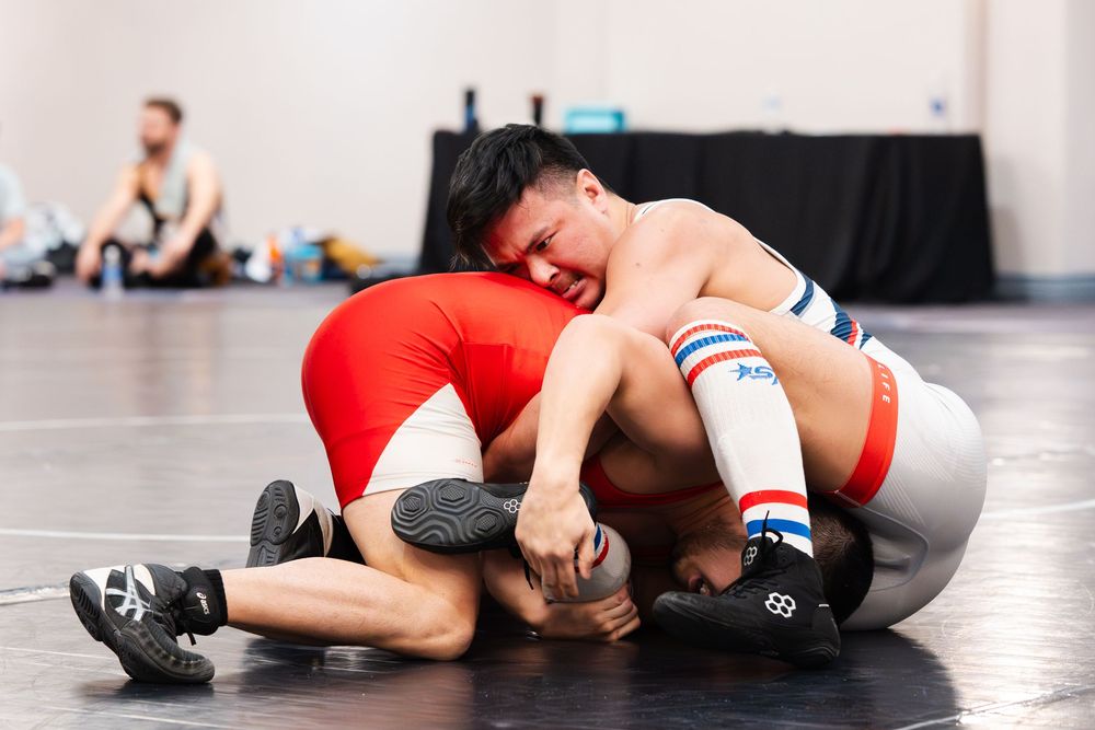 Two wrestlers competing for dominance in a tournament at Sin City Classic hosted by Wrestle Proud and District Wrestling