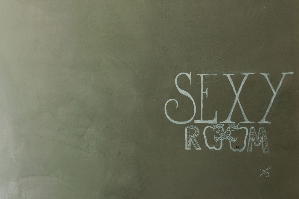 playful sexy room sign detail during groom preparations at DOMA Portugal wedding venue