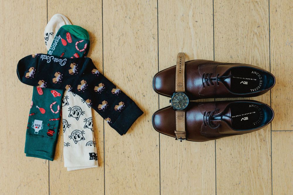 groom accessories with colorful socks shoes and watch before wedding preparations