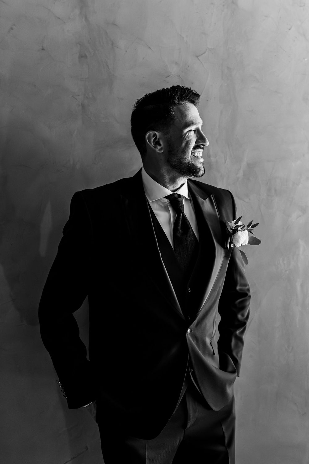 groom portrait in black suit during wedding morning preparations