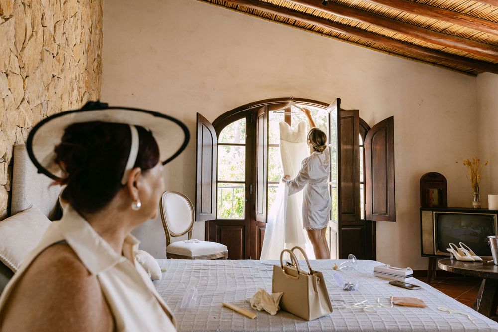 Interior panorama of a rustic bedroom with wooden beams and white bedding in Algarve