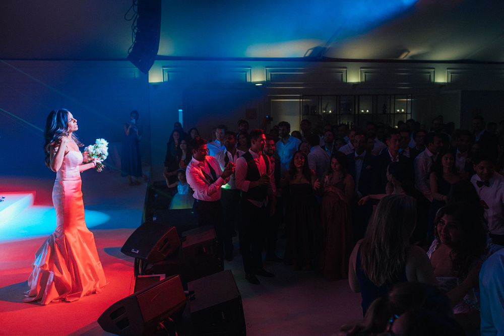 Bride throwing her bouquet during luxury Indian wedding at Palácio do Correio-Mor, Portugal
