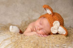 newborn session sleeping baby wearing Fox outfit