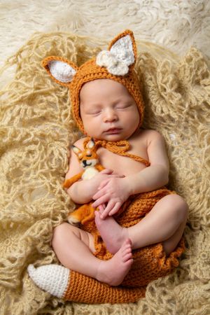 Newborn in crocheted fox outfit Mississauga Studio