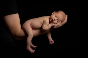 Newborn baby with parent High contract black background