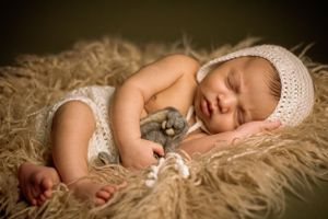 newborn session sleeping baby holding bunny