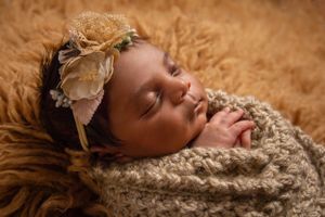 newborn session sleeping baby in handmade wrap