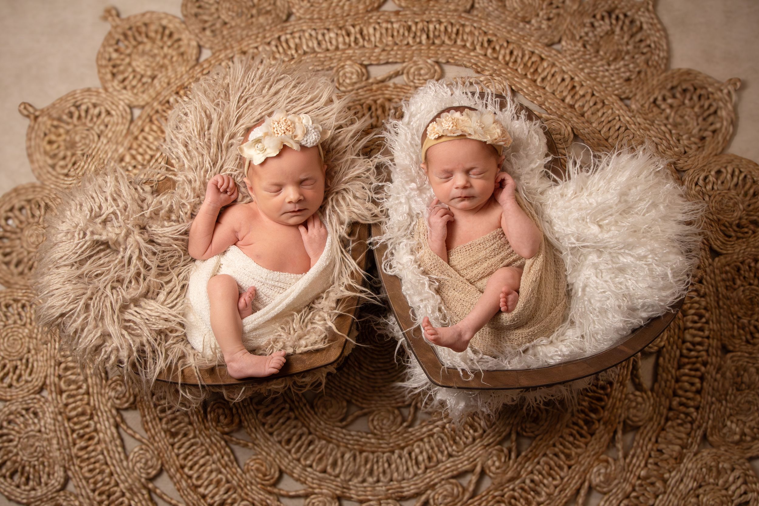 twin girl newborn session with boho setup with 2 heart props