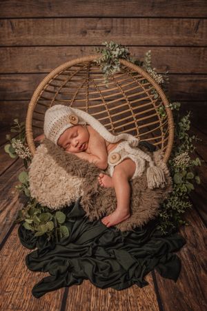 posed newborn in rattan prop mississauga baby session