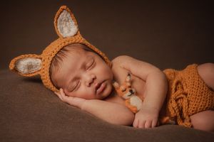 close up of baby boy wearing handmade fox outfit studio session
