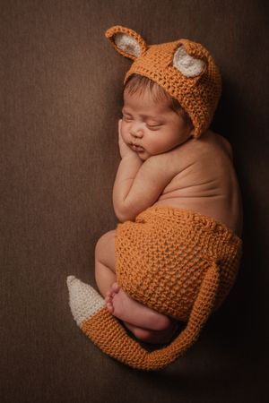 baby boy wearing fox outfit in Erin Mills studio sleeping baby