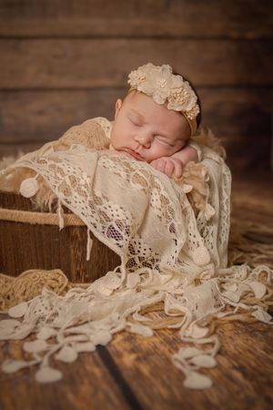 rustic accents in newborn portrait baby girl with lace and barrel prop