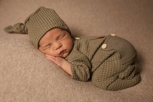 baby boy wearing sleepy hat in bums up pose
