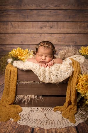 newborn session sleeping baby in crate had on hands